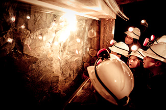 Students looking at gold on an underground Mine Experience Tour at Central Deborah Gold Mine